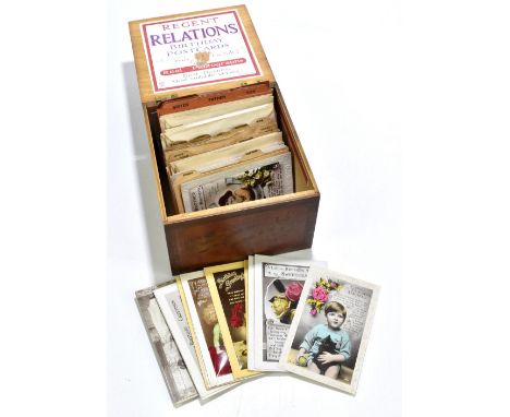A Regent Relations birthday postcards box, with label to the front and underside of the lid enclosing a small selection of va