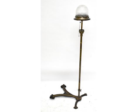 A 19th century gilt metal standard lamp with cut glass domed shade, raised on a single column with galleried section, termina