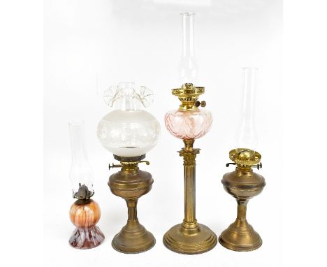 An early 20th century oil lamp with pink coloured glass reservoir, raised on Corinthian column support terminating on plinth 