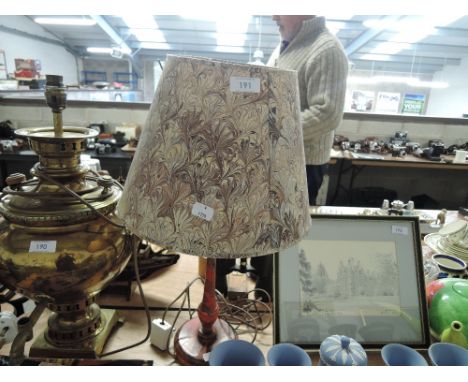 A vintage lamp with marble effect base and shade in a retro bohemian style