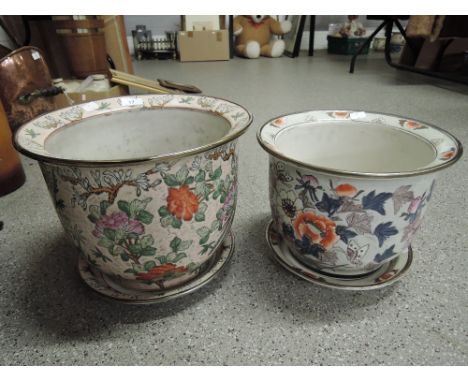 Two ceramic planters with accompanying trays and a Japanese style design