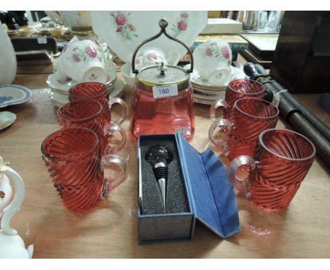 A selection of vintage cranberry glass cups and lidded jar