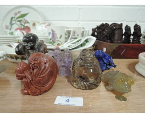 A selection of hand carved figurines from various semi precious stones in a Netsuke oriental style 