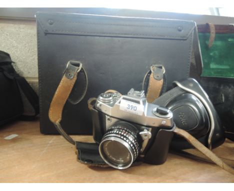 An Exa IIb camera with Mayer-Optix Gorlitz Domiplan 2,8/50 lens, with instruction book, vintage lens, flash, filters all in h