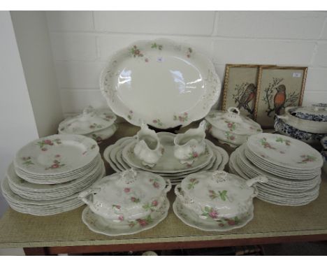 A large vintage dinner service by Johnson Bros with floral motif with gold decal 