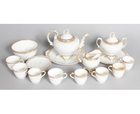 A POKER DOT BLUE PART TEA SERVICE on a white ground with gilt decoration, comprising teapot and cover, milk jug, sugar bowl, 