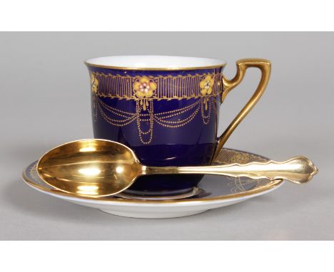 A ROYAL WORCESTER BLUE AND GILT EIGHT PIECE COFFEE SET with silver spoons in a fitted case. Retailed by Mappin & Webb.