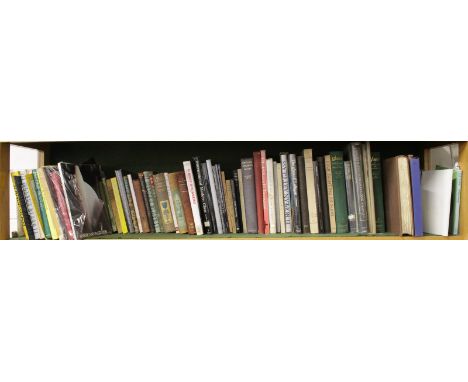 A LARGE SHELF OF APPROX. 100 BOOKS ON GLASS.