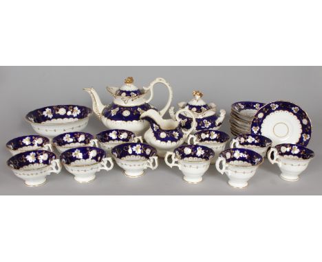 A BLUE AND GILT TEA SET with vine leaves, comprising teapot and cover, sucrier and cover, milk jug, slop bowl, ten cups and e