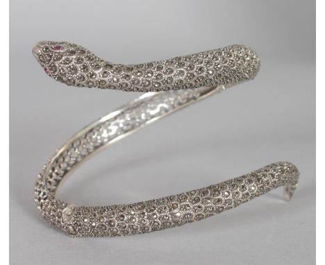 A LARGE SILVER AND MARCASITE SLAVE SNAKE BANGLE with ruby eyes.