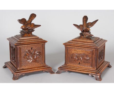 A PAIR OF BLACK FOREST CARVED WOOD SQUARE SHAPED BOXES, one formed as a tea caddy, the other a cigar box with three cigar she