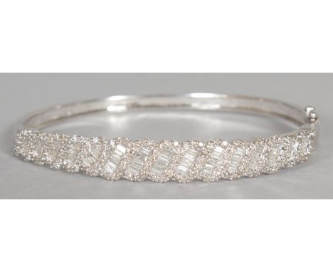 A GOOD 14CT WHITE GOLD DIAMOND SET BANGLE, set with 3cts of diamonds, baguette and princess cut.