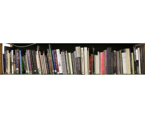 A LARGE SHELF OF APPROX. 100 BOOKS ON GLASS.