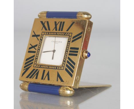 A CARTIER of PARIS QUARTZ TRAVELLING CLOCK with two lapis ends, No. 355116090. 2.5ins, in a red Cartier velvet pocket..