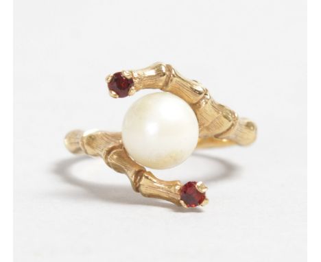 A 9CT YELLOW GOLD, RUBY AND PEARL CROSSOVER RING.