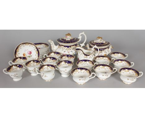 A BLUE AND GILT TEA SET, painted with pink roses, comprising teapot, sucrier and cover, milk jug, sixteen various cups and ei