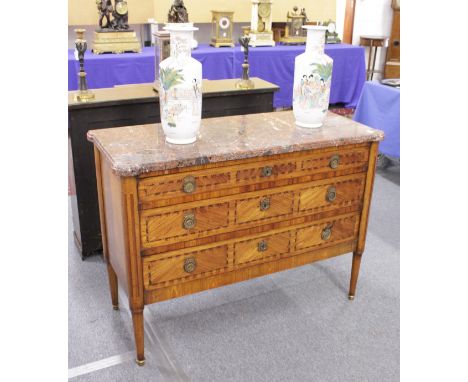 A LOUIS XVI DESIGN STRAIGHT FRONTED KINGWOOD COMMODE, with veined marble top, three graduated long drawers, on turned legs. 3