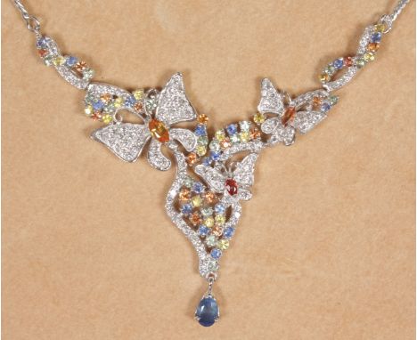 A LOVELY SILVER BUTTERFLY PENDANT set with coloured stones including sapphire, peridot etc, on a silver chain.