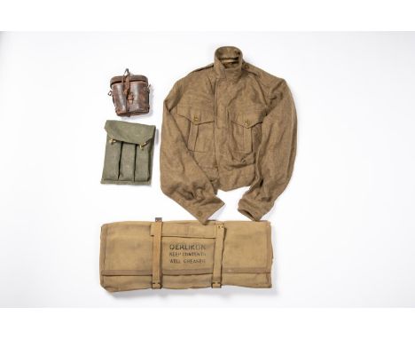 A WWII cover for an Oerlikon gun, a 1949 pattern BD blouse; a pair of WW1 German field glasses (AF); also a triple magazine p