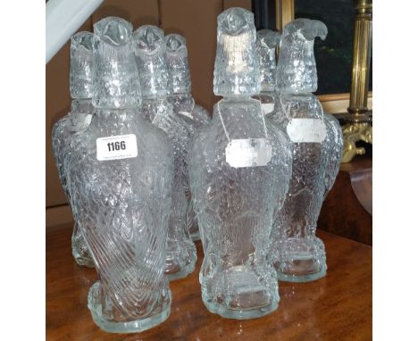 A GROUP OF SEVEN EAGLE HEADED DECANTERS, six with decanter labels.