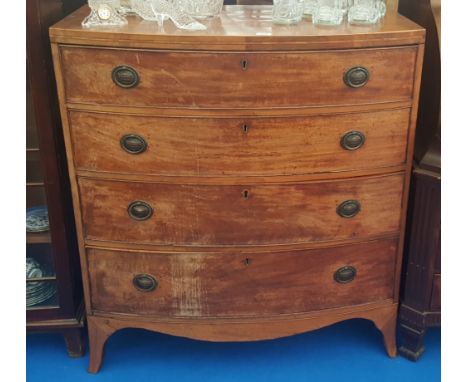 A GEORGIAN MAHOGANY BOW FRONT CHEST with four graduated drawers.