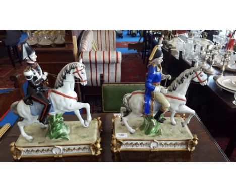 A GOOD PAIR OF CERAMIC CONTINENTAL MILITARY MEN on eagle surmounted bases (a/f).