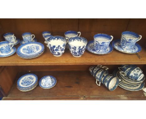 A QUANTITY OF 19TH CENTURY BLUE & WHITE COPELAND & LATER BOOTHS CHINA CUPS, SAUCERS & PLATES (2 shelves).