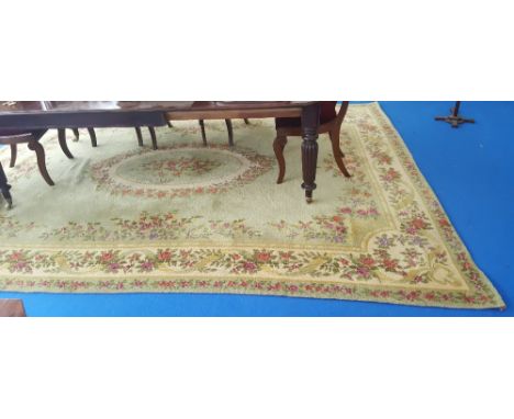 A LOVELY FLORAL DECORATED 100% WOOL CARPET ON A GREEN AND CREAM GROUND with Kroon Imperial Holland label, 11'7" x 8'1".