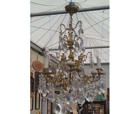 A POLISHED BRASS AND CRYSTAL SIX BRANCH CHANDELIER of neat proportions.
