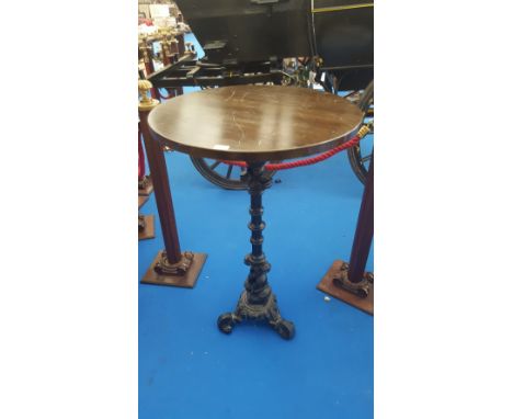 A BAR HIGH TABLE on cast iron decorative tripod base.