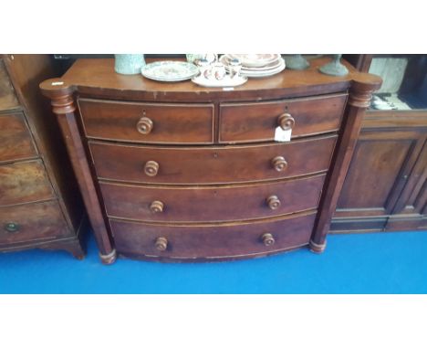 A MID TO LATE 19TH CENTURY MAHOGANY BOW FRONT CHEST OF DRAWERS with two short over three long with original knobs and octagon