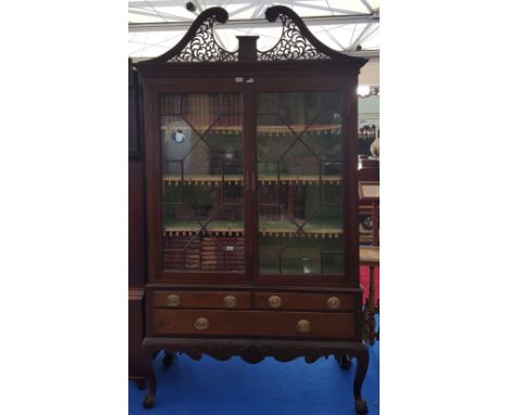 A SUPERB EARLY 19TH CENTURY MAHOGANY IRISH DISPLAY CABINET with shell carved base, glazed doors and architectural pediment.
