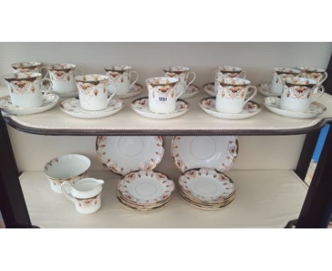 A GOOD 20TH CENTURY PART TEASET WITH GILT DESIGN,  with twelve cups, ten saucers, ten side plates, jugs etc.
