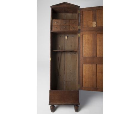 A MAGNIFICENT 19TH CENTURY OAK GUN CABINET WITH ARCHITECTURAL DESIGN with R & J Watkins, 40 Harrington St, Dublin label to th