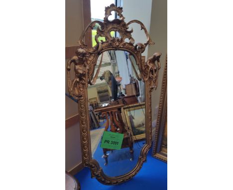A SUNSTANTIAL VICTORIAN PLASTER GILT PIER MIRROR with cherubs holding swags and with highly carved surround.