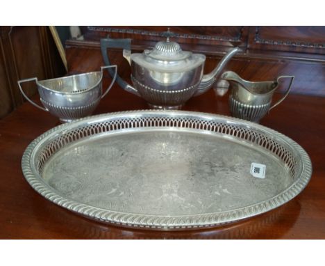 A HALF REEDED THREE-PIECE SILVER- PLATED TEA SERVICE on a rope edged oval tray.