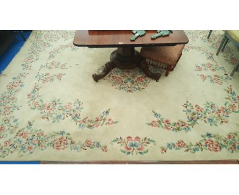 `A LARGE CREAM GROUND CARPET, 100% WOOL, with pink/green/blue foliate decoration. 12ft x 8ft 8ins.