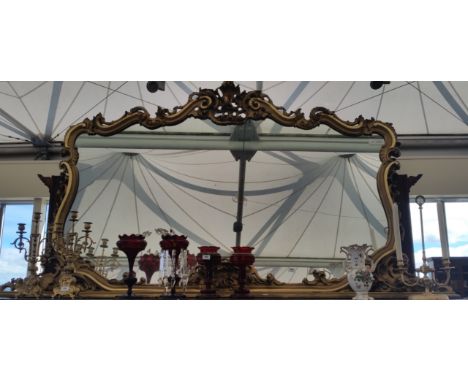 AN EXTREMELY SUBSTANTIAL VICTORIAN TIMBER GILT OVERMANTEL MIRROR with highly carved surround circa 1880-90.