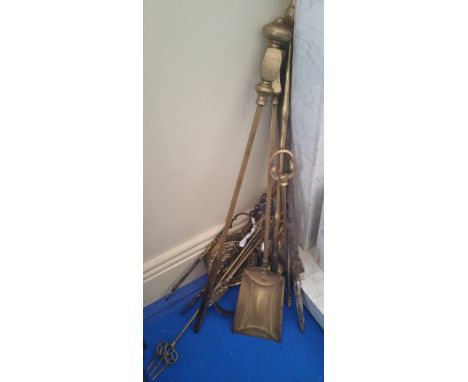 A QUANTITY OF BRASS FIRE UTENSILS, bellows, toasting fork, etc.