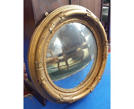 A REALLY GOOD 19TH CENTURY TIMBER GILT CONVEX MIRROR with turned and carved surround.