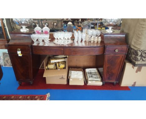 A WONDERFUL EARLY 19TH CENTURY MAHOGANY PEDESTAL SIDEBOARD with a bow shaped front fitted with two drawers two tapering pedes