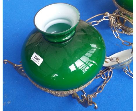 A MODERN POLISHED BRASS HANGING OIL LAMP of neat proportions fitted with a green glass shade.