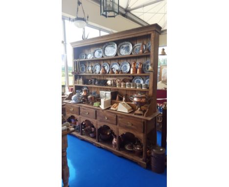 A GOOD 20TH CENTURY PINE KITCHEN DRESSER  with four open shelves to the top and five small drawers above four large drawers a