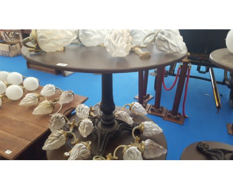 A LARGE CIRCULAR BAR TABLE with heavy decoration and cast iron tripod base.