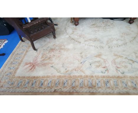 A NEARLY SQUARE LARGE CREAM GROUND CARPET with multi borders and leaf decoration 13'3" x 12'10".