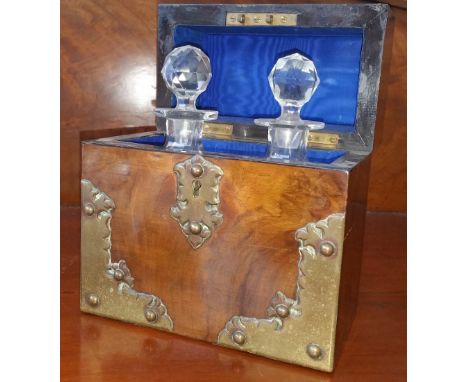 A BURR WALNUT CAMPAIGN DRINKS CADDY with two fitted bottles and with brass mounts. (Sir Malcolm's Great Room).