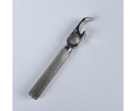 A vintage bottle opener crafted with a sterling silver textured handle and a sturdy steel head, marked Made in Germany. The p
