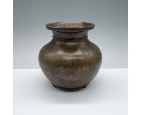 Decorative bronze footed vessel with ring design detail going around the center and top. Unidentified mark on outside center.