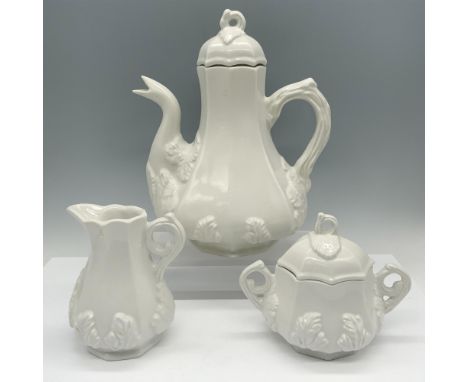 Elegant glossy collection with a grape pattern in low relief that contains a tea pitcher with a lid, a creamer jug, and a sug