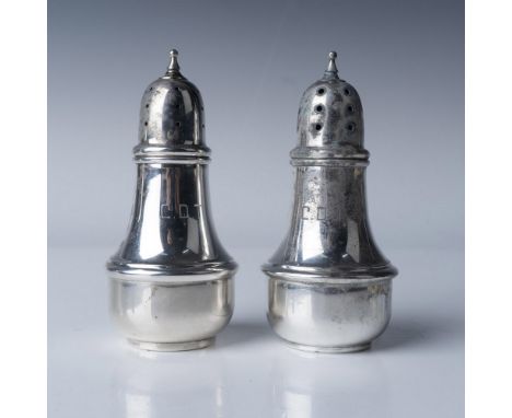 A pair of sterling silver salt and pepper shakers by Lenox Silver Inc., New York City, marked FSC-99. The pieces feature an e